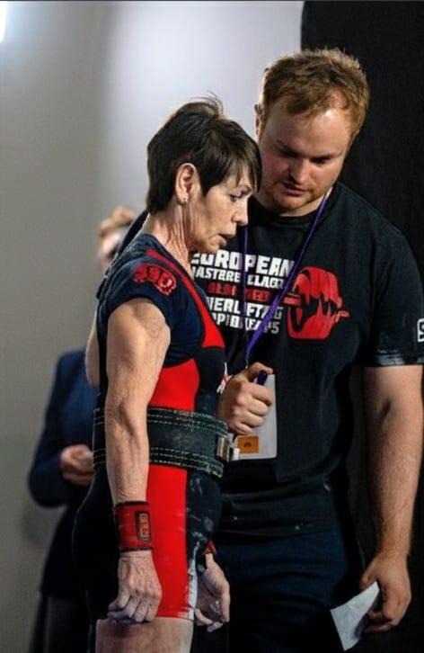Coach and athlete going through the attempt plan backstage before a lift
